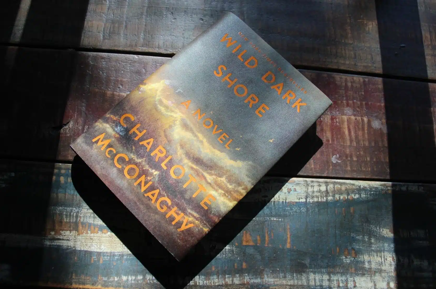 Copy of the hardcover of the book mentioned on wooden slats